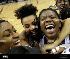 Central Arkansas', from left, Brianna Mullins, Olivia McWilliams and Sandy  Jackson celebrate with teammates after defeating Sam Houston State in an  NCAA college basketball game in the championship of the Southland Conference