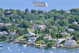 Aerial Banner References Dan Koh and AI Backers Ahead of MA-06 Primary