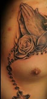 Rose praying hands body art 16. 51 Stylish Praying Hands Tattoos On Chest