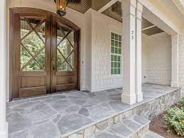 Flagstone (flag) is a generic flat stone, sometimes cut in regular rectangular or square shape and usually used for paving slabs or walkways, patios, flooring, fences and roofing. Flagstone Porch And Beautiful Doors By Horizon Custom Builders Stained In Minwax Jacobean Front Porch Stone House With Porch Stone Porch