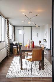 Modern rugs are a great way to add vibrant colors to your space and designs unlike any other. Resources Inspiration From A Warm And Happy Modern Home Rug Under Dining Table Dining Room Rug Dining Table Rug