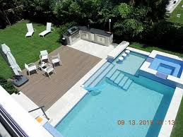 Swimming Pool With Swim Up Bar Connected To Outdoor Kitchen Hot Tub At Luxury Home In Biscayne Florida Pool Houses Modern Pools Backyard Pool