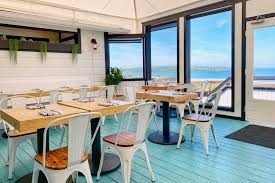 This amazing coastal kitchen makeover has white kitchen cabinets, a seaglass blue coastal backsplash, mixed metals and weathered oak floors. Dillon Beach Coastal Kitchen Serves Up Sunny Dishes With An Ocean View Sonoma Magazine