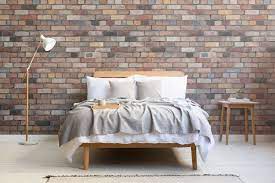 Printed with a photographic brick wall effect, this patterned wallpaper is finished with a sophisticated matt effect finish. Mixed Brick Wallpaper Mural Hovia