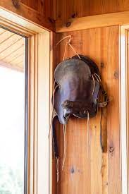 An Old Western Saddle Hanging On The Wall Western Decor Western Home Decor Equestrian Decor