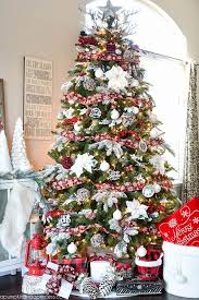 Pretty woman near christmas tree unwrapping present. Upgrade Your Christmas Tree Game With These Decorating Ideas Amazing Christmas Trees Cool Christmas Trees Pretty Christmas Trees