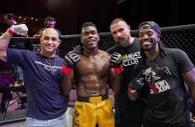 Stan Dorsainvil with his corner team in the cage after a win