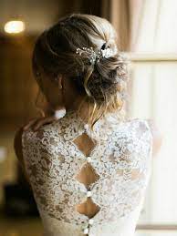 Cocktail drinks passed at cocktail hour. Close Up Of A Blonde Bride Facing Backwards Wearing Her Hair In A Messy Bun With White Ornaments And Wedding Dress Backs Wedding Dresses Lace Wedding Dresses