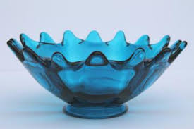 The base of the dish is clear glass and has a diamond shaped pattern. Mod Glass Candy Dishes