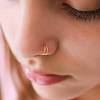 A ball creates more stability but may cause some pain if the hole of your nose piercing isn't big enough to accommodate the ball. 1