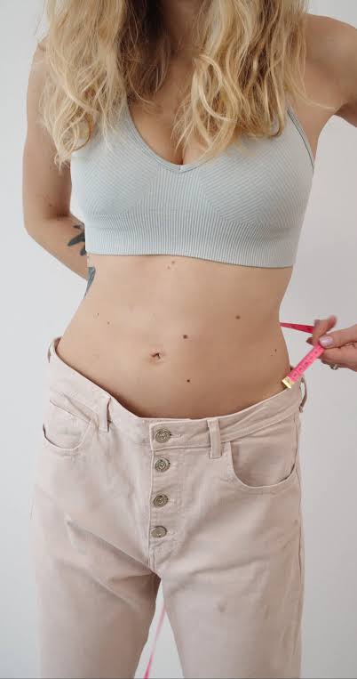 A Man Measuring a Woman's Waistline