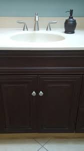 Decorating a small bathroom can be tough and choosing the perfect color scheme can be even harder. Dark Brown Chalk Paint Did Wonders For My Light Cabinets Painting Bathroom Cabinets Painted Vanity Bathroom Brown Painted Cabinets