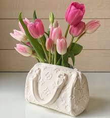 It's a device that is designed to create a mould for the production of a vessel (in bond's case, a vase or a shallow dish). Handbag Shaped Flower Vases Bodega Rose