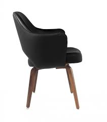 These chairs also feature splayed front legs and an angular back for a comfortable look and this classy chair has camel color upholstery with dark brown legs, giving it the ability to match your existing decor. Saarinen Dining Armchair Leather Wood Legs Eero Saarinen Njmodern Furniture