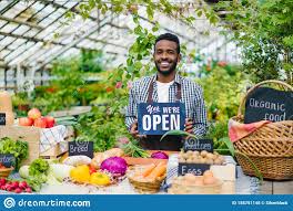 Salesman In Apron Holding Open Sign In Organic Food Market Welcoming People Stock Photo Image Of Nutrition Autumn 158751148