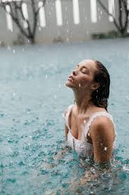 Woman In A Pool Swimming In The Rain By Jessica Lia Stocksy United Rain Photography Pool Photography Swimming Pool Photography