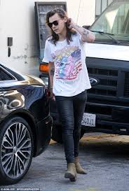 Chelsea boots have become the artist's signature outfit staple. Harry Styles Cuts A Cool Figure In A Graphic T Shirt And Skinny Jeans In Beverly Hills Daily Mail Online