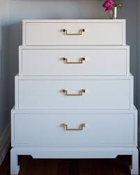 This white tall dresser will renew the look of a modern bedroom, especially when paired up with the white bedside table and a low dresser of the same designer. Michael Taylor New World White Brass Pulls Dresser