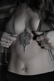 Ornamental Tattoo On The Upper Stomach Between The Breasts Very Delicate Brown Color Would Be Gorgeo Brustbein Tattoo Design