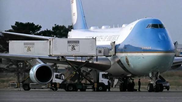 A composite image showing Air Force One on a tarmac and a ground-level view of a transport vehicle, representing the clandestine extraction mission.