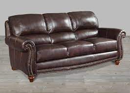 If the brown leather pieces in your living room make the space feel stodgy and uninviting, incorporating pops of bold, vivid color can help liven up the space. Brown Leather Rolled Arm Sofa With Nailheads
