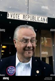 State Senate President DAVID WILLIAMS smiles while walking under a sign  reading "Vote Republican" following a campaign rally for Republican U.S.  Senate nominee Rand Paul at Graves County Republican Headquarters. Williams  is