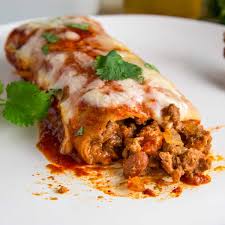 My favorite beef enchiladas recipe loaded with a saucy, hearty, and flavorful ground beef filling, then smothered with enchilada sauce and melted cheese. Ground Beef Enchiladas Kevin Is Cooking