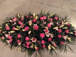 For decades, pink flowers have been used to decorate weddings as a symbol of love. Funeral Flowers Rose And Lily Coffin Spray Pink Rose And Pink Lily Funeral Flowers Pink Funeral Funeral Flowers Sympathy Flowers Funeral Flower Arrangements