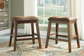 This set of three stools is the perfect addition to a kitchen counter or home bar. Chaleny Counter Height Bar Stool Ashley Furniture Homestore Counter Height Bar Stools Bar Stools Upholstered Stool