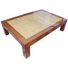 A clear glass top with a beveled edge makes a lovely surface for your books, magazines or tv tray. Handsome Ralph Lauren Wood And Sea Grass Coffee Table At 1stdibs