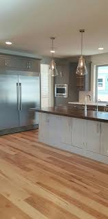 And if you love hickory's grain but aren't so hot on the color because hickory flooring is so hard, it's difficult to dent, scratch, or otherwise damage it. Gorgeous Spacious Kitchen Natural Hickory Floors 2 Toned Painted Gray Cabs Hickory Wood Floors Wood Floors Wide Plank Kitchen Flooring