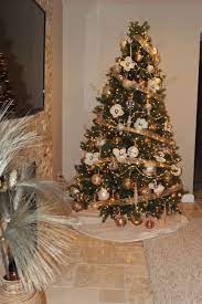 If you need christmas balcony ideas, this tree along with artificial poinsettia plants for outside may be just the ticket! Gold Ribbon Ornaments And Magnolia Flowers Make Up This Beautiful Christmas Tree Christmas Tree Beautiful Christmas Trees Beautiful Christmas