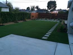 When compared to other solutions, such as paving, an artificial lawn will compare very favourably. Artificial Turf With 12 X12 Pavers Walkway And Drought Resistant Plants Turf Backyard Artificial Grass Diy Artificial Turf