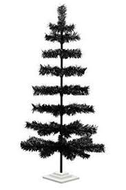 If black christmas trees aren't quite your speed, take things in the opposite direction and learn how to flock a christmas tree , or even go super bold this blogger opted to decorate her black christmas tree with black and white ornaments (including whimsical faux flowers and branches) with touches of. 18 Best Black Christmas Tree Ideas Decorate Black Christmas Trees
