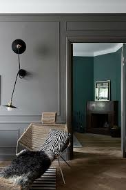 The dark color can help to ground the room, drawing the attention downward and evening out the space visually. A Scandinavian Home With Grey Walls In All Its Glory Decoholic