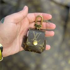 The Louis Vuitton Apple Airpods Case Custom Key Features 1 Made Using An Authentic Re Purposed Lv Duffle Iphone Accessories Apple Accessories Earbuds Case