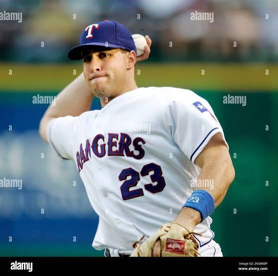 Texas Rangers' Mark Teixeira (23) makes a throw to a teammate as he warms up prior to the start of the game against the Tampa Bay Devil Rays during MLB baseball action