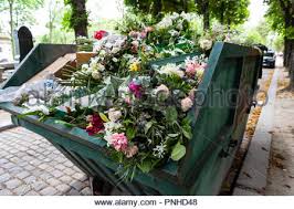 Insert the spiked end of the grave vase into the soil on the grave. A Dumpster Filled With Discarded Flower Arrangements That Were Left Behind On Graves From Visitors At The Pere Lachaise Cemetery Paris France On A C Stock Photo Alamy