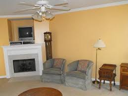 Gray, gold, and tan in the fireplace's stone provide inspiration for the living room colors used elsewhere. A Shade Of Yellow Tan Paint On Our Living Room Walls