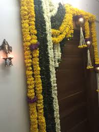 Door Decor For Diwali With Flower Garlands And A Ganesh Diya Door Flower Decoration Door Decorations Diwali Decorations