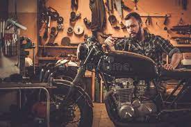 Mechanic At Motorcycle Customs Garage Mechanic Building Vintage Style Cafe Race Sponsored Garage Building Cu Motorcycle Mechanic Cafe Racing Mechanic