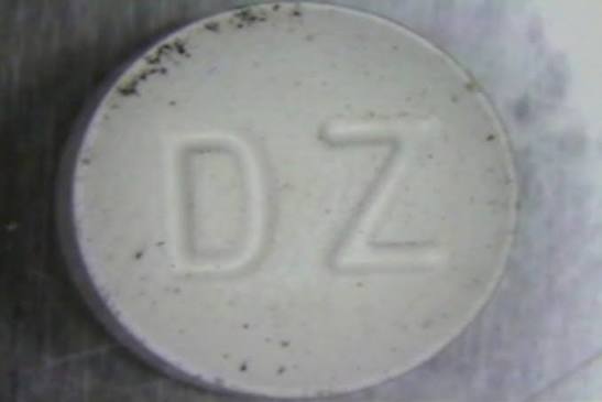 A tablet showing visible discoloration, suggesting the medicine has degraded