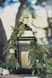 Melanie I Really Love This The Simplicity Of The Florals Draping From The Lantern Is Beautiful And Wedding Centerpieces Lantern Centerpieces Wedding Lanterns