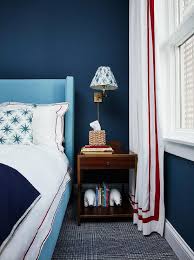 When considering boy's bedroom ideas for small rooms, turn to light blue as its airy shade makes a space look bigger. Sky Blue Wingback Bed On Dark Blue Wall Transitional Boy S Room