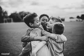 Black And White Kids Hugging Download Premium Photo Of Junior Football Team Hugging Each Other 529077