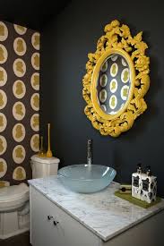 A single yellow chair brings some life into a completely black bathroom. Yellow Accents Eclectic Bathroom Nest Interior Design