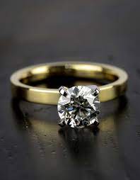This Near Colorless Diamond Set On A Flat Yellow Gold Band With White Gold Prongs M Round Diamond Engagement Rings Engagement Rings Internally Flawless Diamond