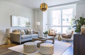 Designing With Round Ottomans Poufs Chairish Blog Living Room Design Small Spaces Ottoman In Living Room Living Room Seating