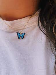 A radiant blue topaz adds a pop of color to this striking butterfly pendant. Blue Butterfly Necklace Sunkissed 901