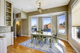There are a few main players in the dining room design: Dining Room In Light Olive Color With Hardwood Floor Blue Rug And Green Dining Table Set Stock Photo Picture And Royalty Free Image Image 30283376